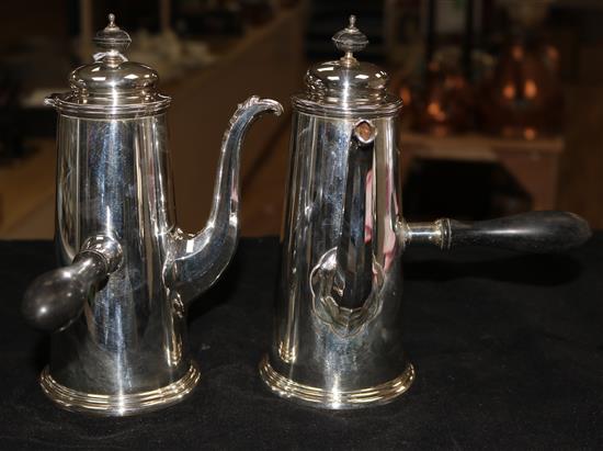 A pair of silver chocolate pots with ebonised handles and finials, Sheffield 1906, James Dixon & Sons Ltd